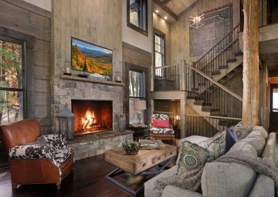 Rustic staircase overlooking great room interior in Jasper, Georgia by Modern Rustic Homes